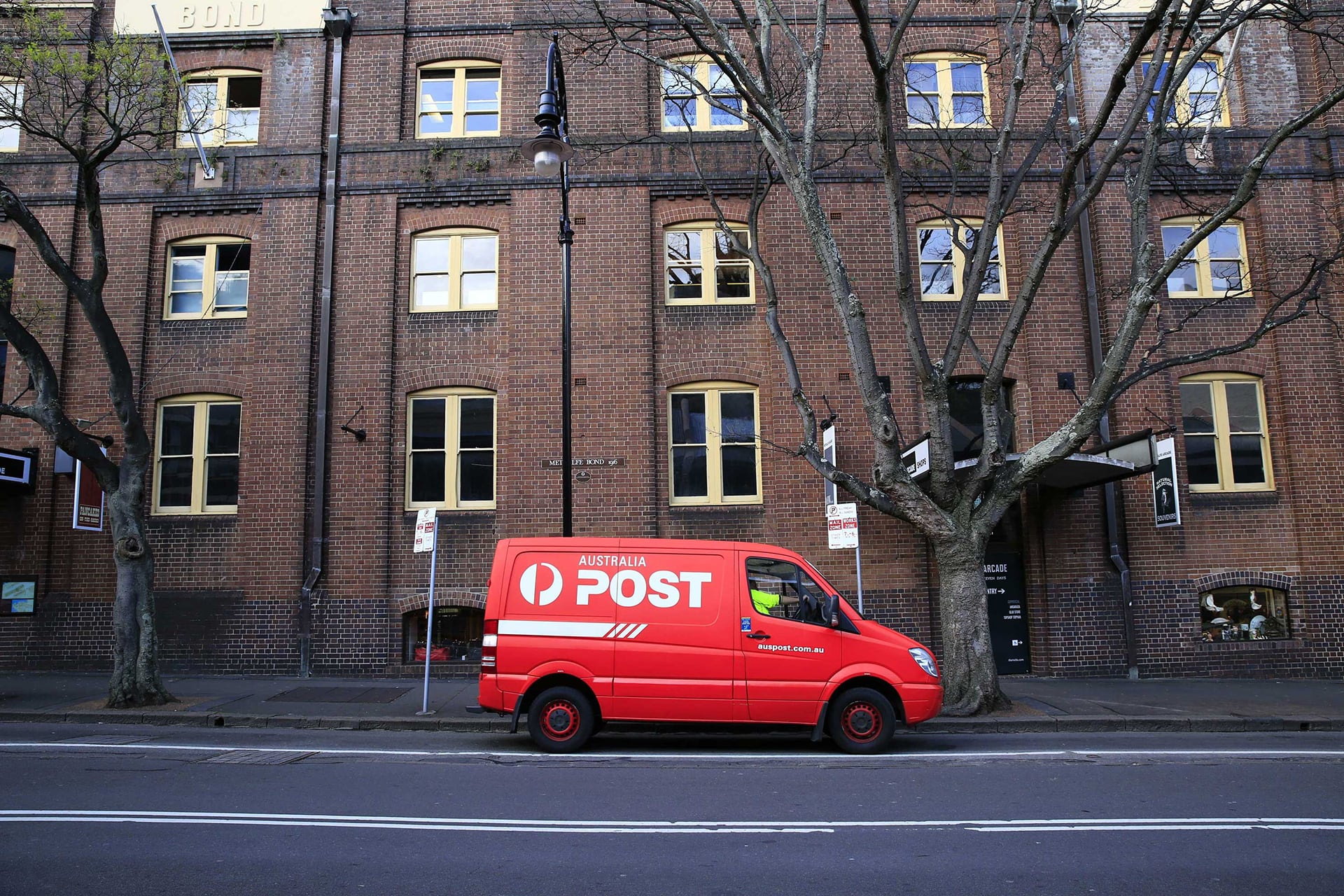 direct mail with Autralian Postal van outside building direct mail with Autralian Postal van outside building
