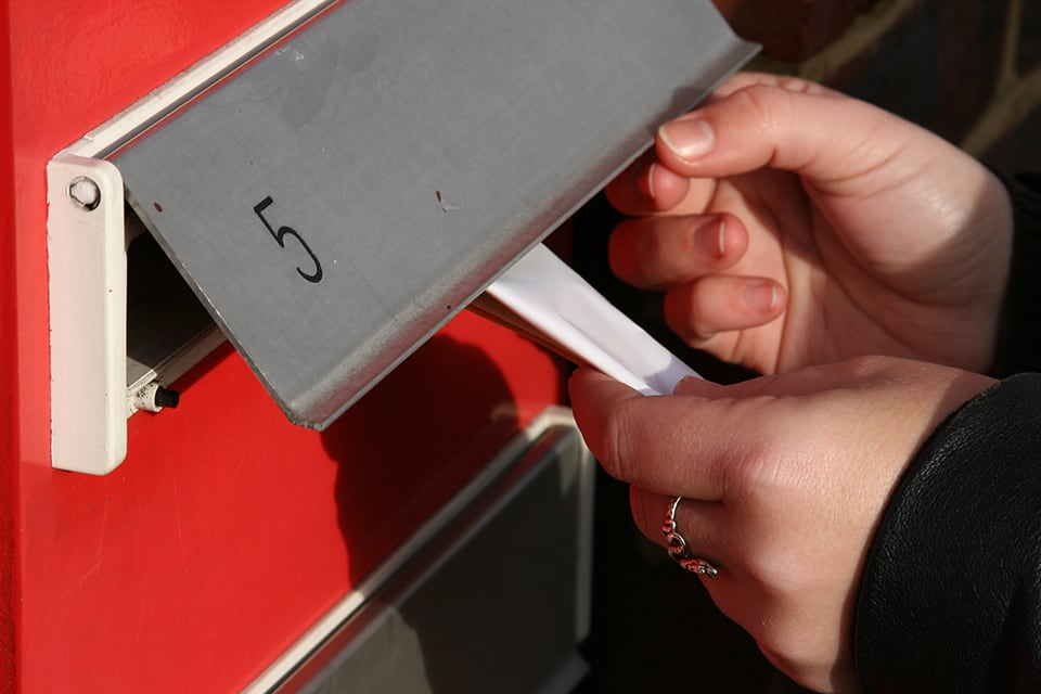 letterbox distribution with person putting mail in letterbox letterbox distribution with person putting mail in letterbox