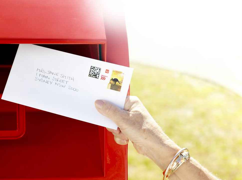 Alpha Mail, person posting letter Alpha Mail posting a letter