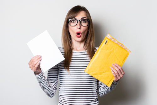 woman suprised happy opening mail woman is suprised and happy opening mail
